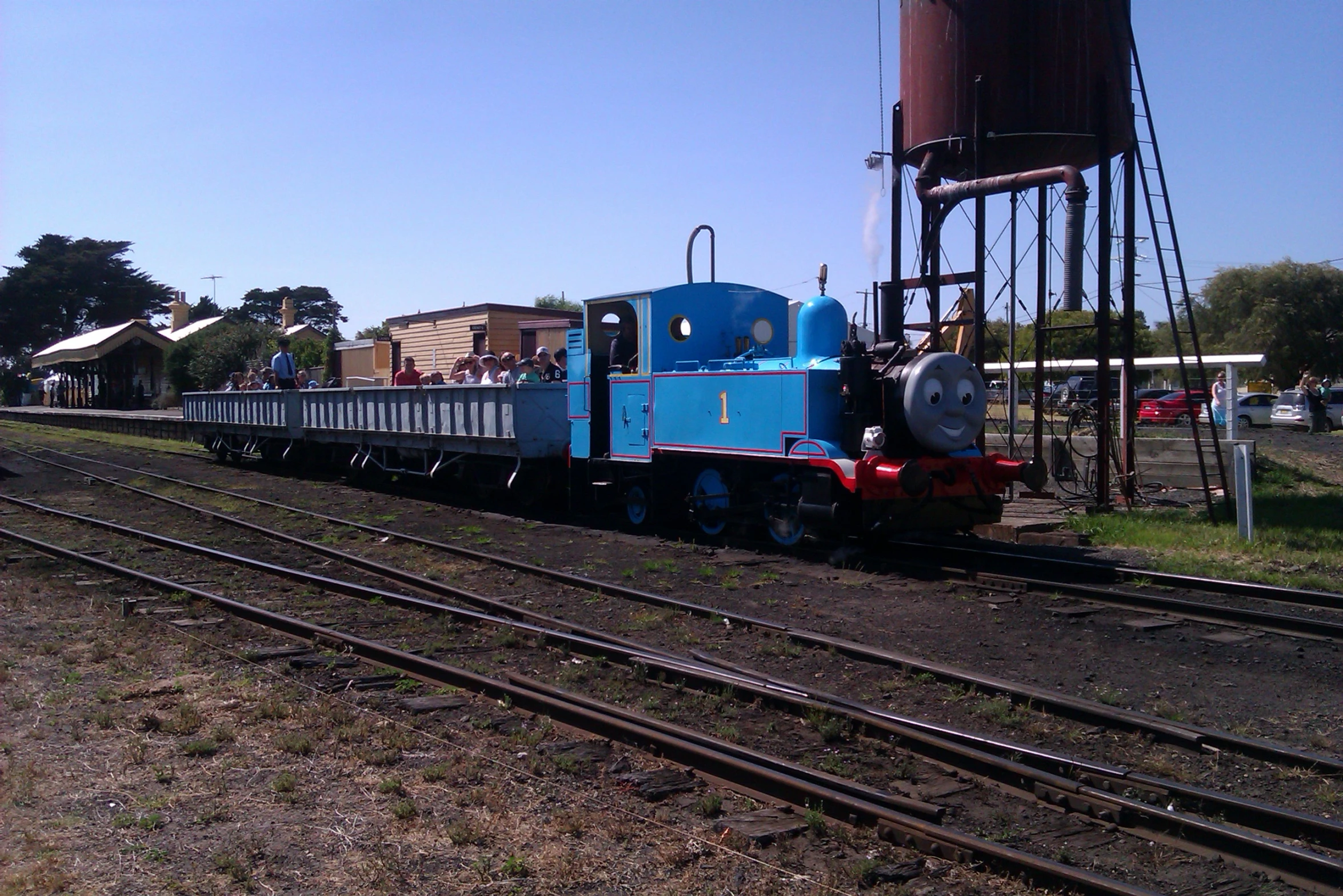 the train car is blue and red, and on its tracks