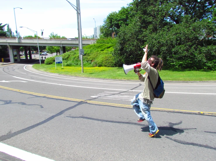 a man holding up a camera and holding a megaphone in the air