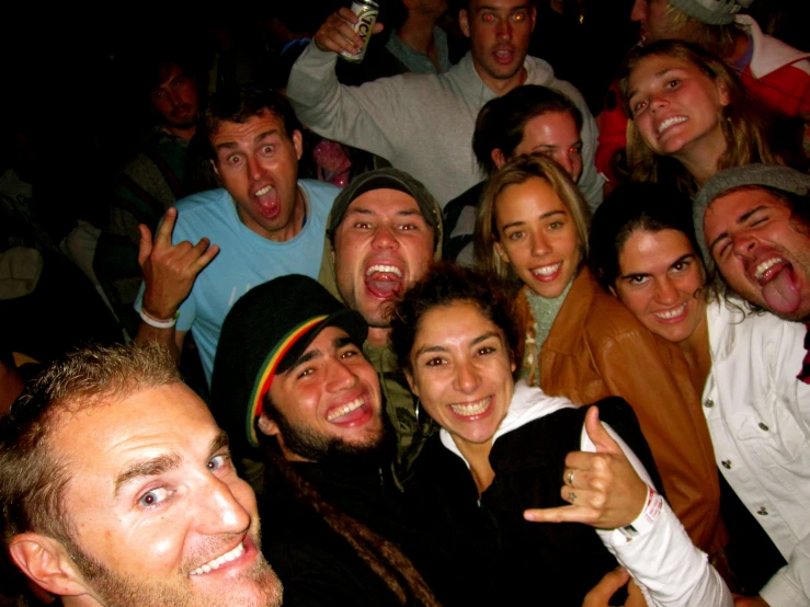 group of people smiling and posing for camera with beer glasses