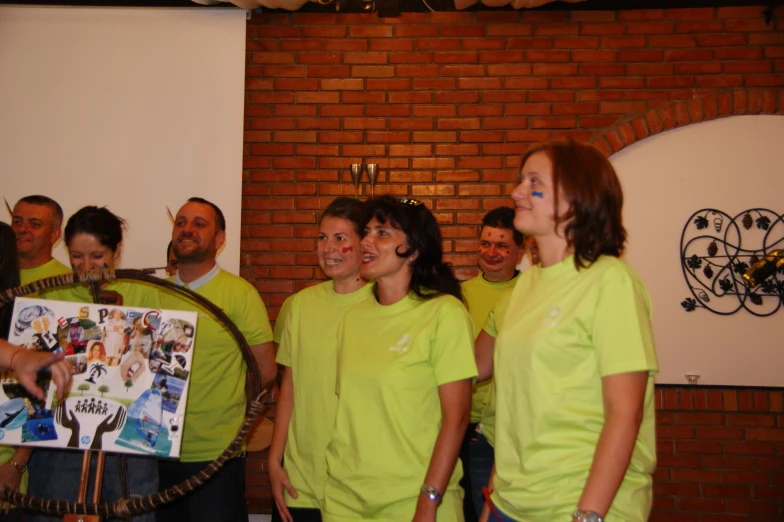 group of people standing together in front of brick wall