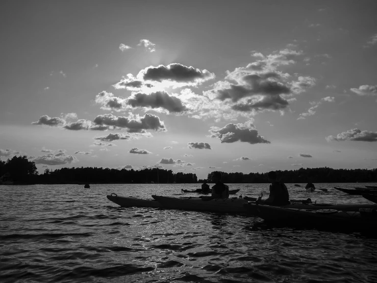 two people in canoes are fishing from the water