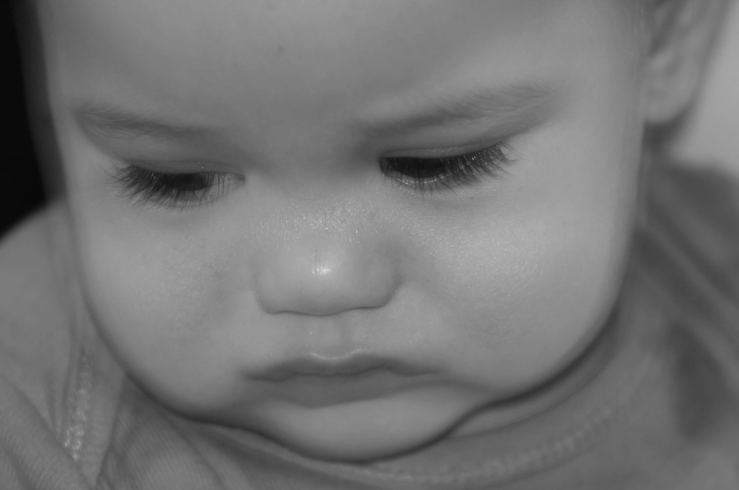 the head of a baby with black lashes and eyes