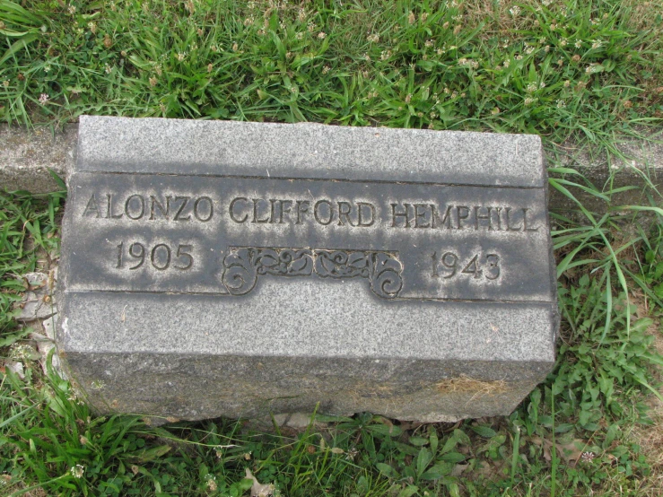 a close up of the memorial on the lawn of an older home