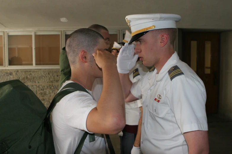 men in dress uniforms hold their hands together