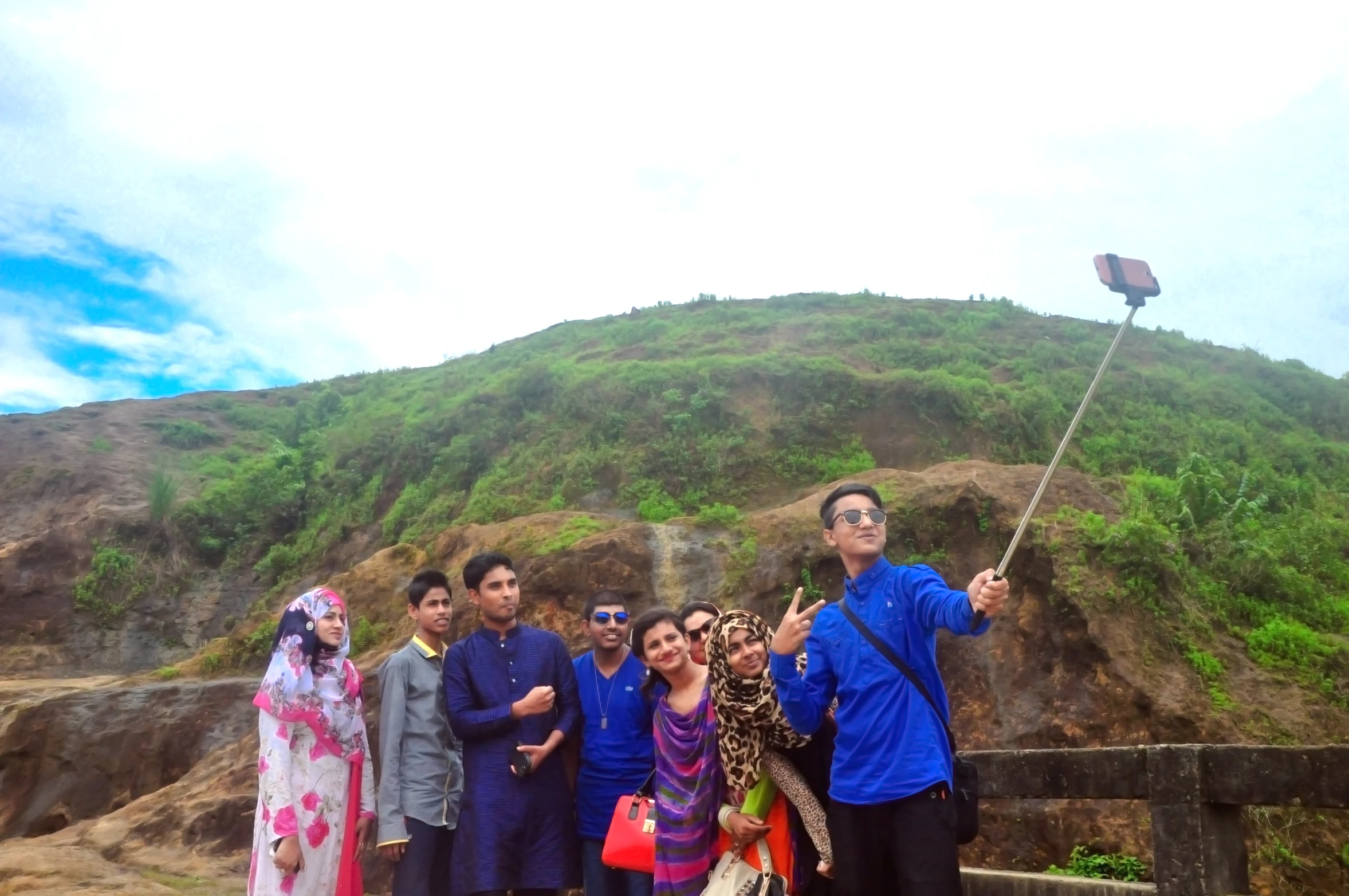 a group of people are on a bridge taking a picture