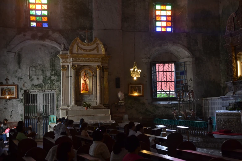 an old church with stained glass windows and stained pillars