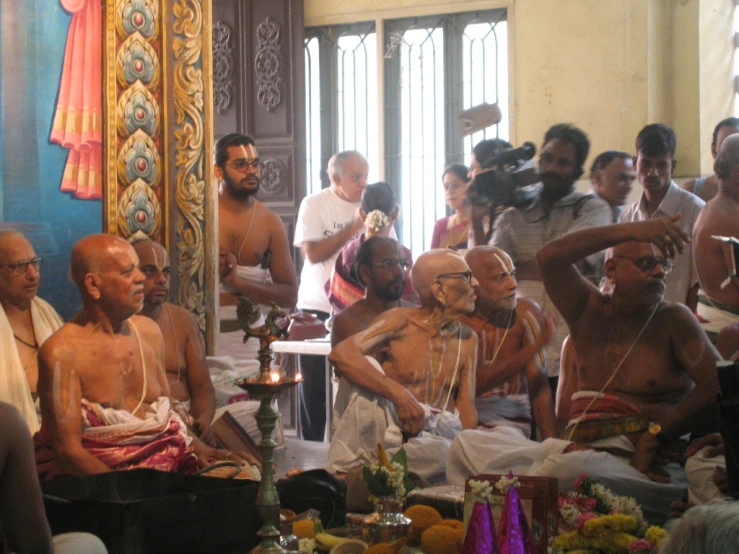 a group of people are gathered together to perform a yoga