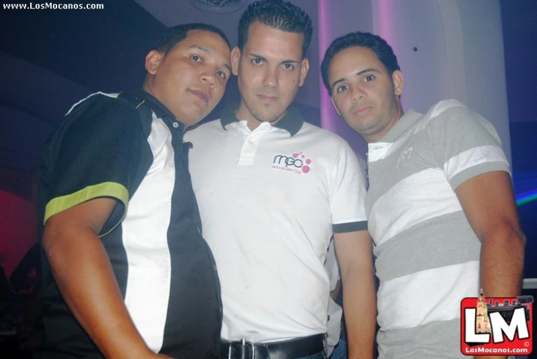 three men are posing for a po in ties