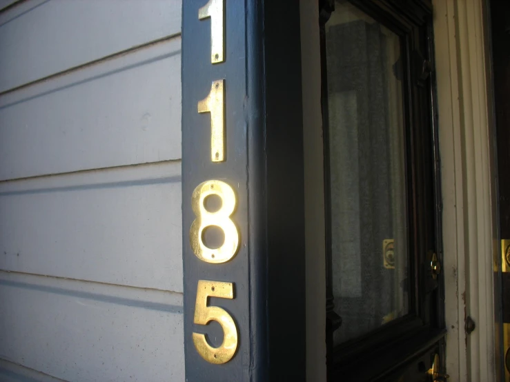 a house number sign is displayed on a door