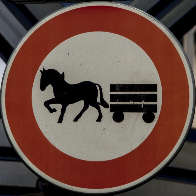 a red and white sign with a black horse and cart