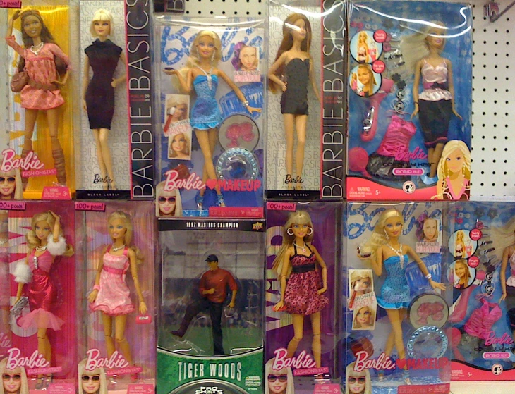 six barbie dolls are on sale, in a store display