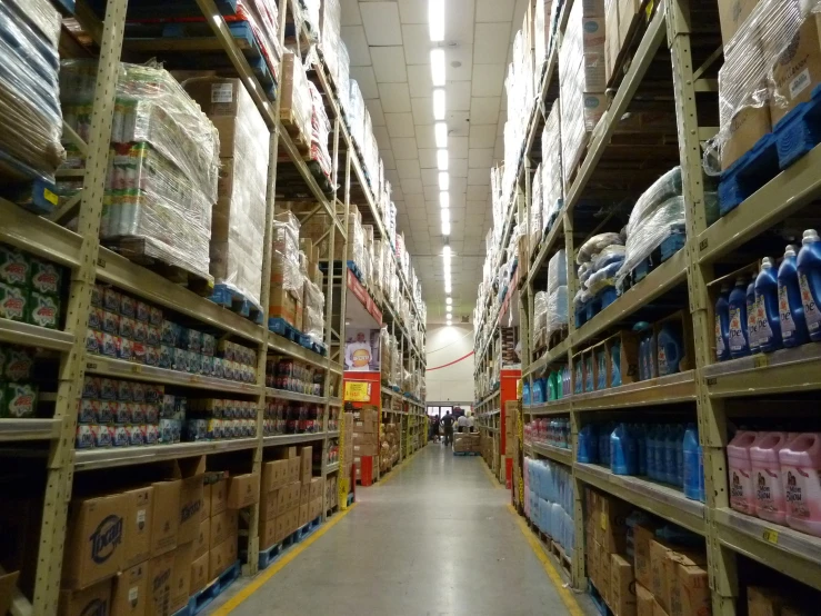 a large long aisle full of various kinds of water bottles