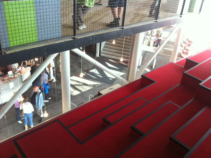 people walk up and down the steps in an area that's red carpet