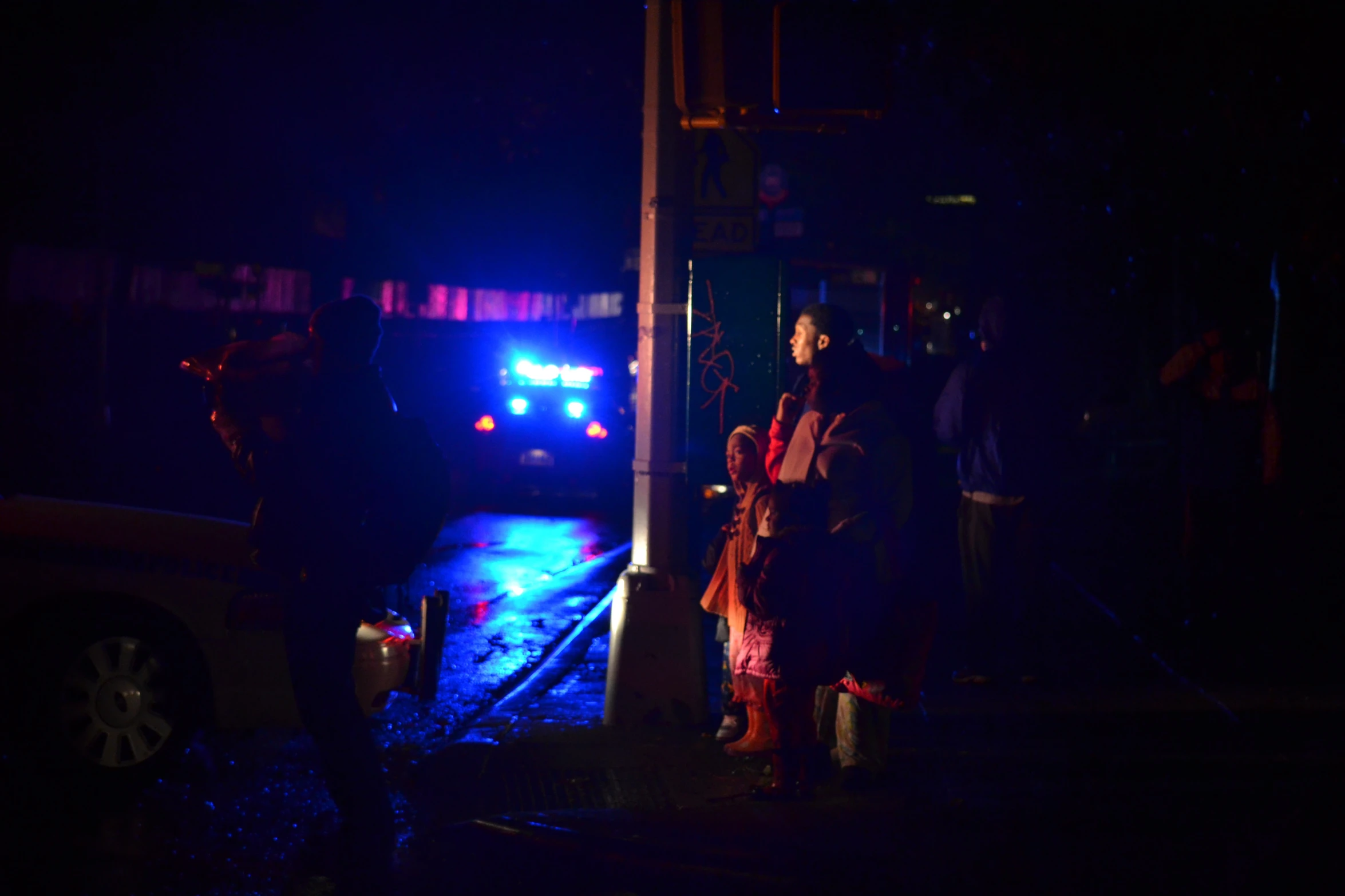 a man standing in front of a bus at night