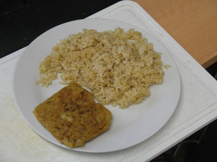 some type of food on a plate with rice and meat