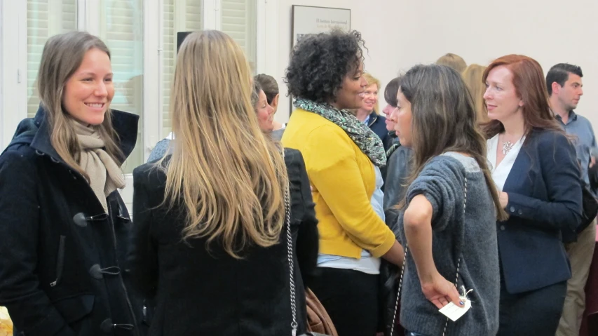 a group of women standing around each other