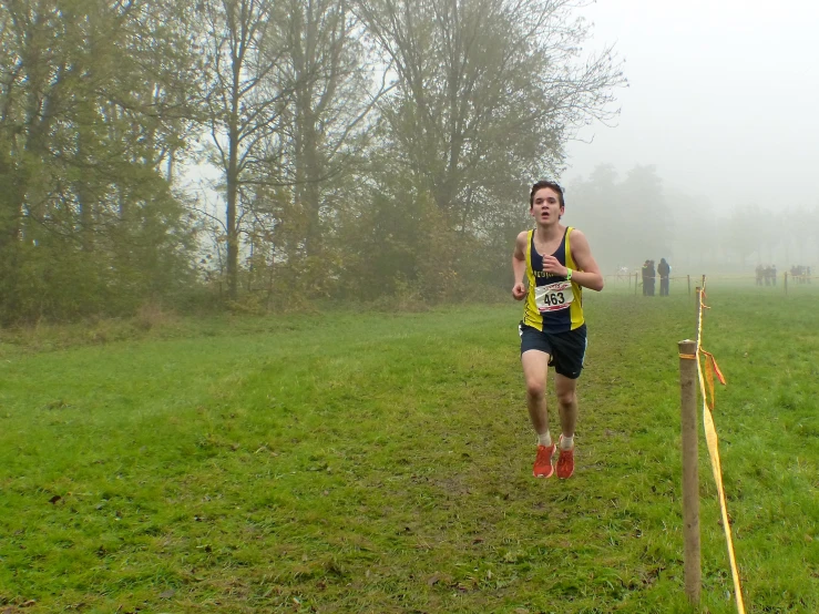 a man running down a foggy path