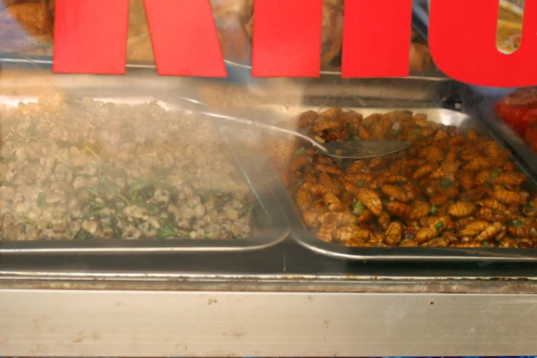 a number of dishes with food on trays near each other