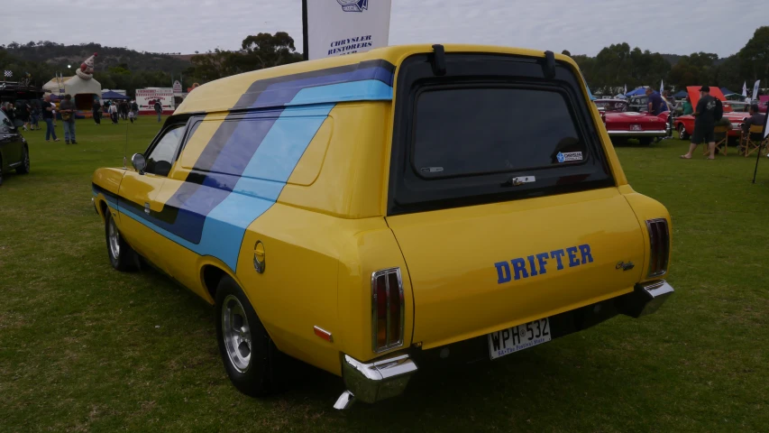 a bright colored truck with stripes is parked in the grass