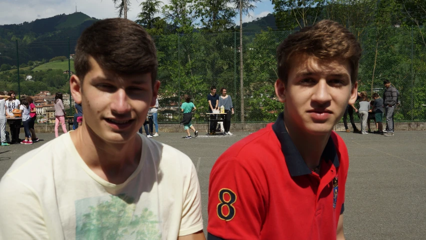 two young men standing next to each other