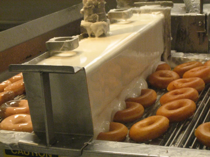 a conveyor belt filled with lots of doughnuts