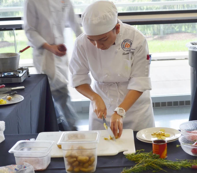 two cooks in the background and on each side of them prepare food