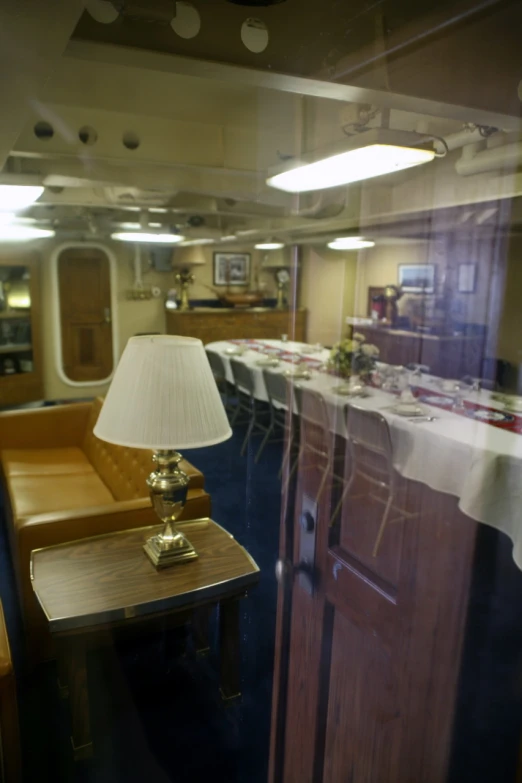 a long table with a lamp next to a cabinet