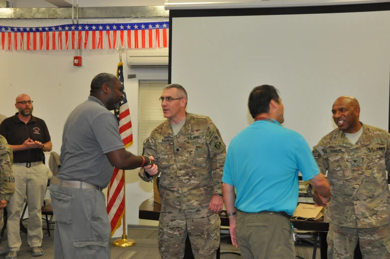 some military men are talking to each other in a room