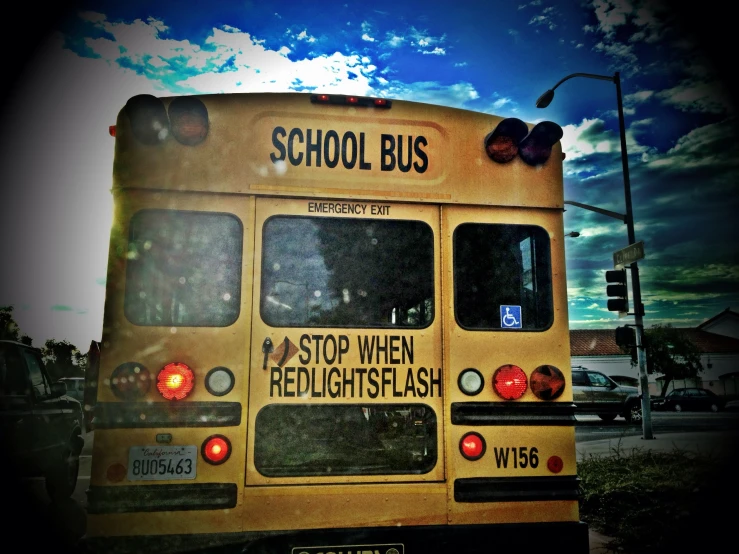 a bus is stopped at a stop light with the lights turned on