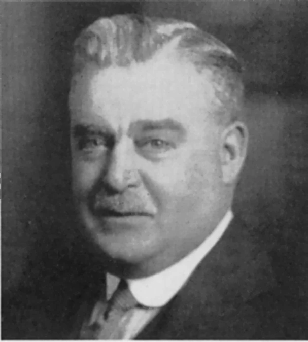 a portrait of a man wearing a suit and tie