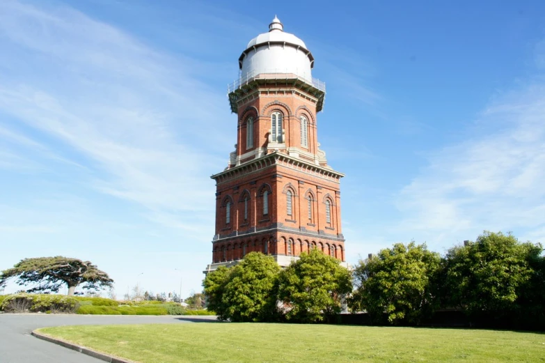 a large red brick tower with a white top