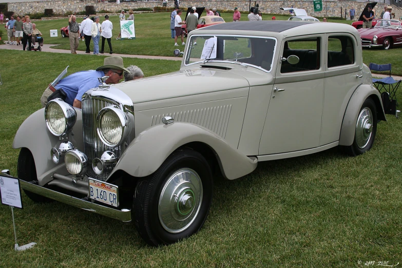 an old model car parked at a classic car show