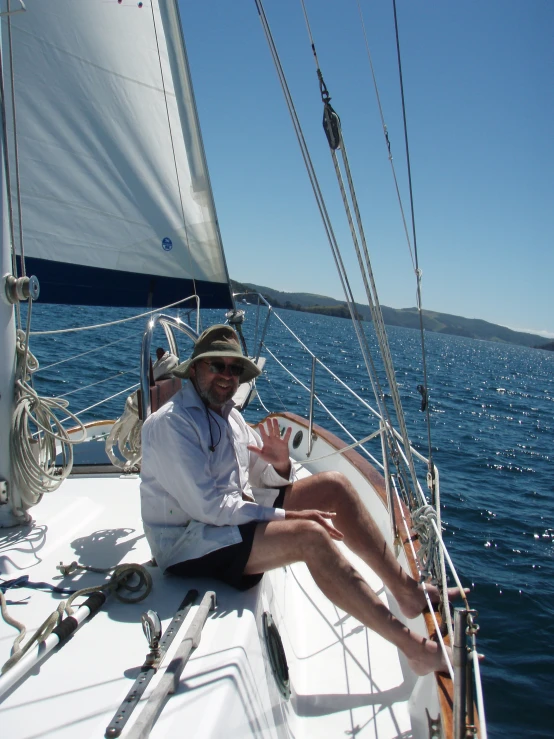 a man with sun glasses sitting on a boat