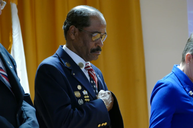 a man with glasses on his head in a suit