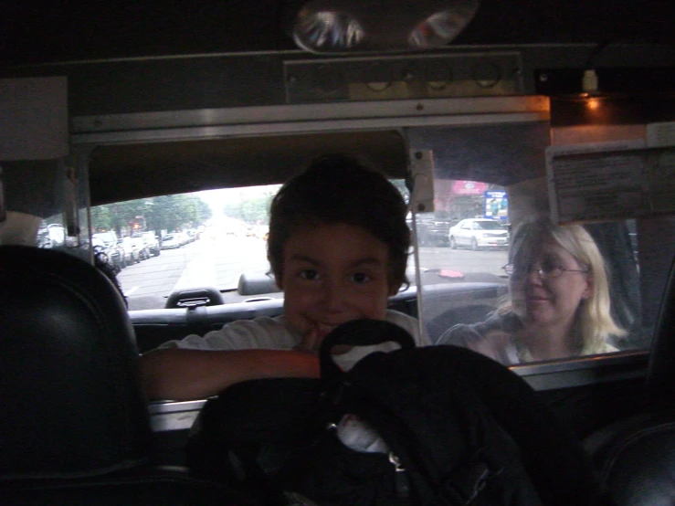 two people in a car sitting side by side