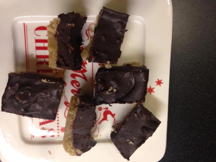 a group of pieces of chocolate fudge cake on a white platter