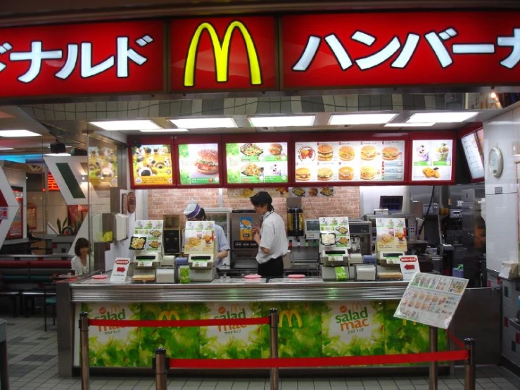 the front of a mcdonalds restaurant with customers