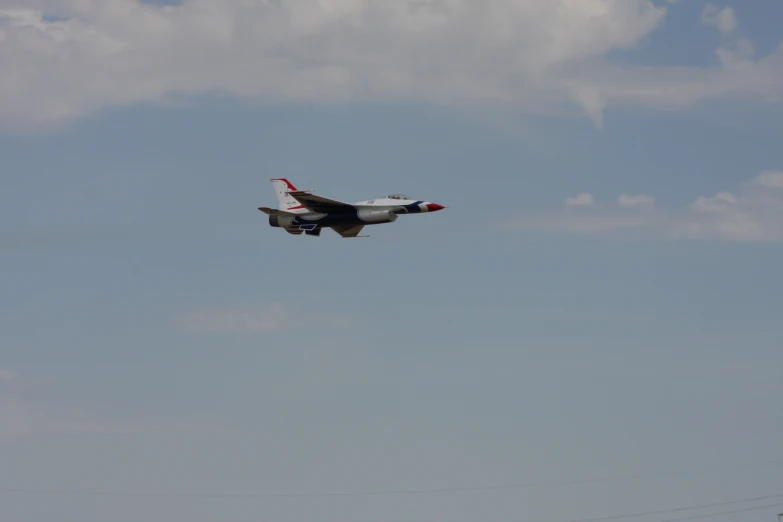 the plane is flying on its wheels in a blue sky