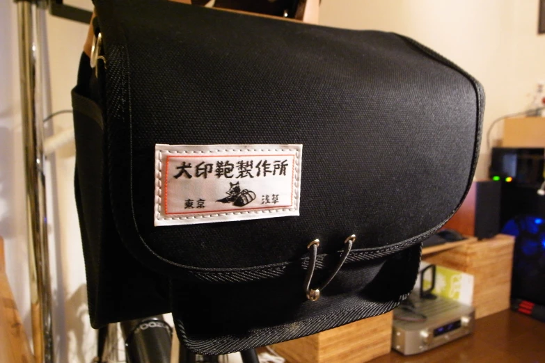 a suitcase with an embroidered label on it