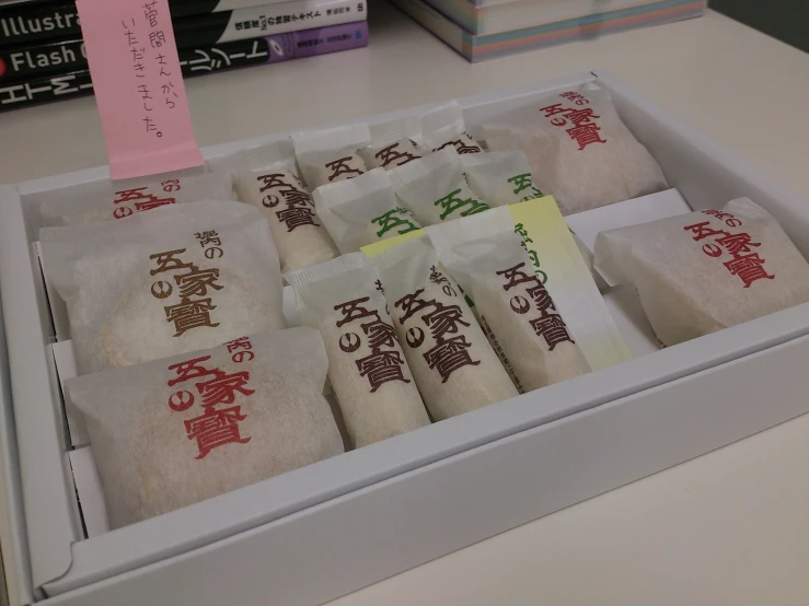 various rolls of food with asian writing in a box