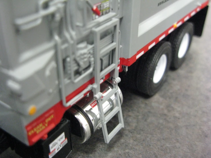 a toy truck with its door open and ladder down