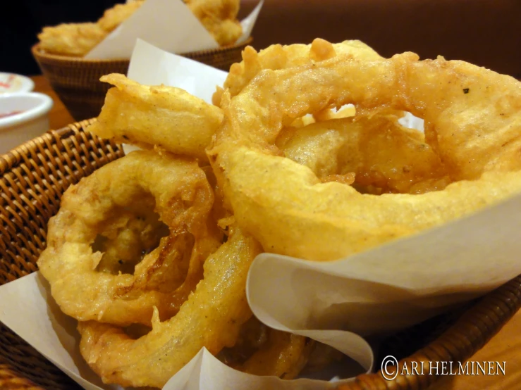 an up close view of onion rings in a basket