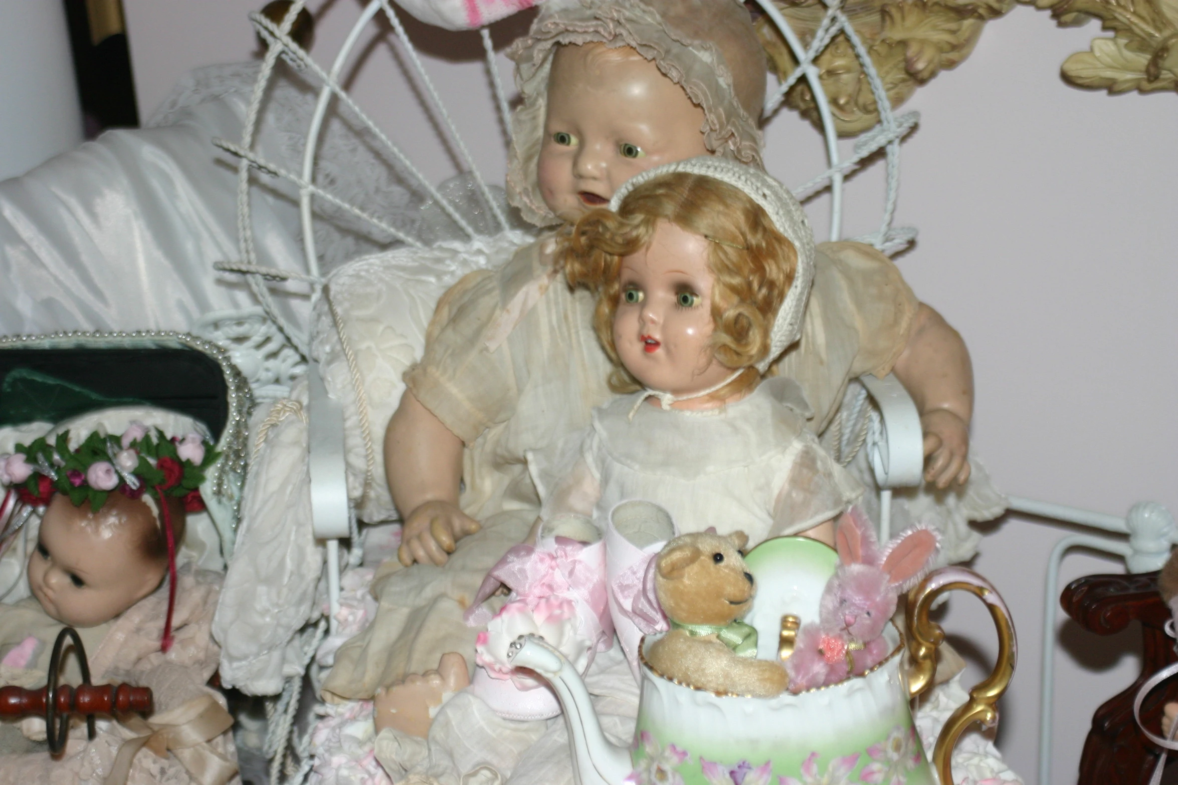 a group of dolls sitting on top of a chair