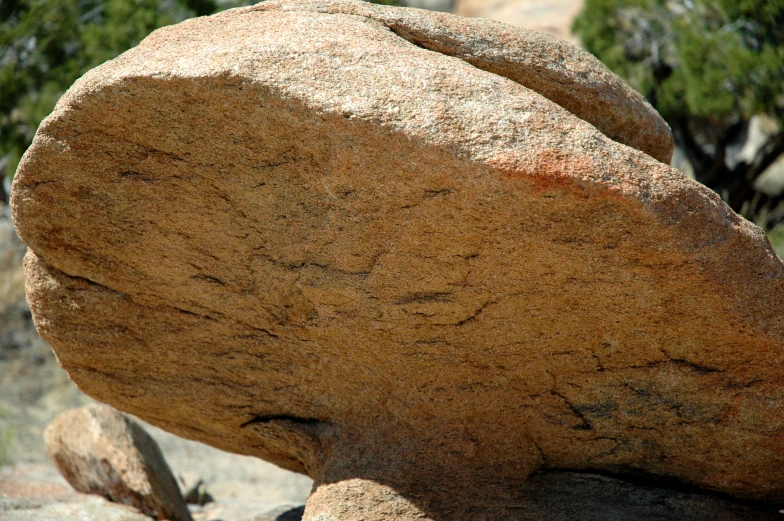 some rocks in a desert with trees and rocks