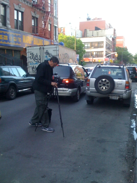 an older man standing on a skateboard in the middle of the street