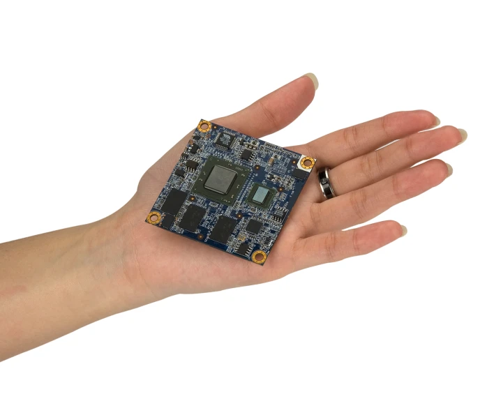an individual holding a micro processor chip in their hand