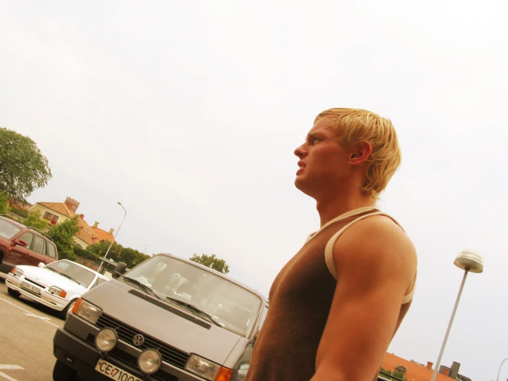 a man standing in the middle of traffic next to a car