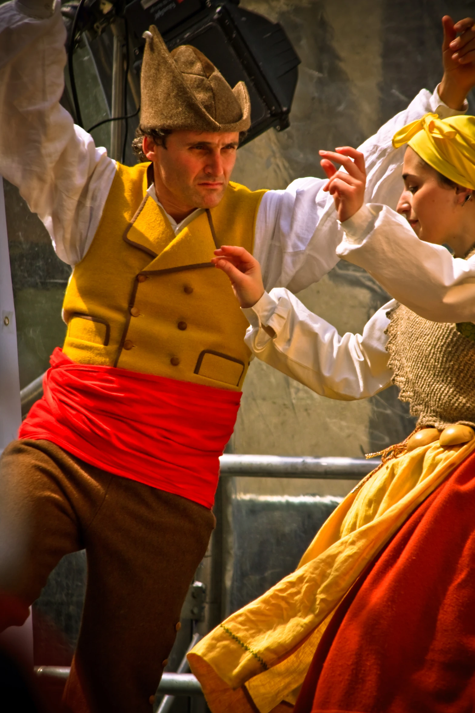 a man and woman dressed in costume performing a dance