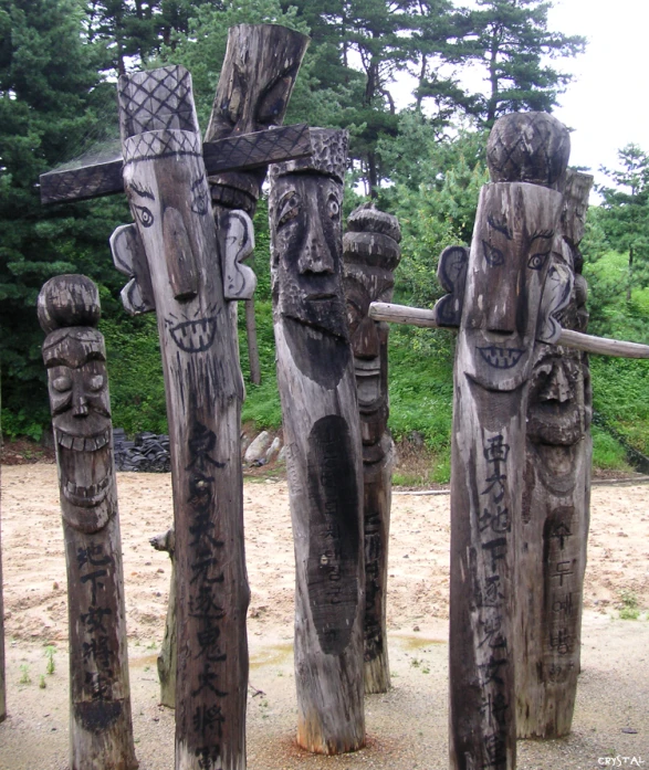 a group of carved wooden statues next to each other