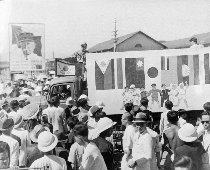 people standing in the street watching a parade